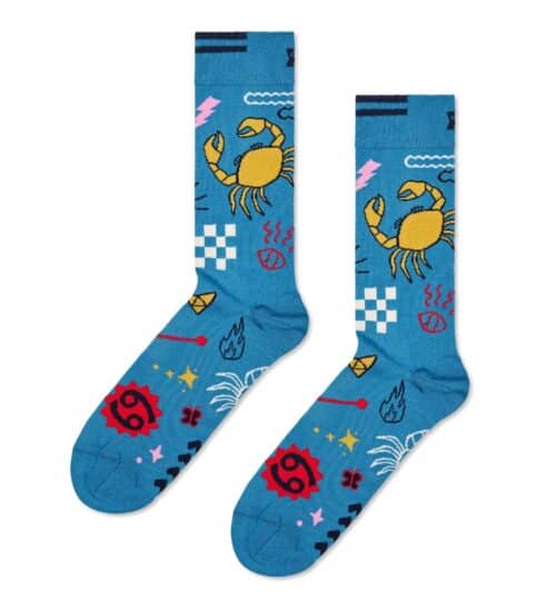 Bright blue socks featuring a yellow crab, red symbols, and playful patterns for cancer awareness an.