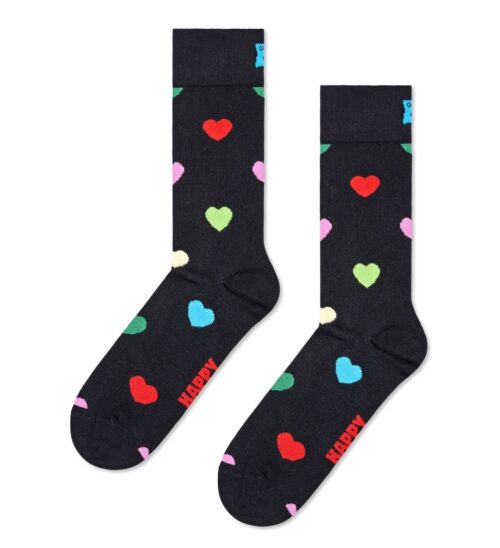 Colorful heart patterned socks with red, pink, green, blue, and white hearts on a black background.