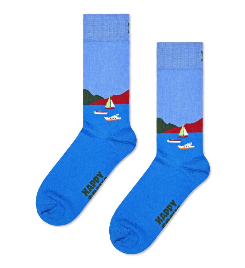 Blue boat-themed socks with sailboats and water scene, perfect for nautical style.