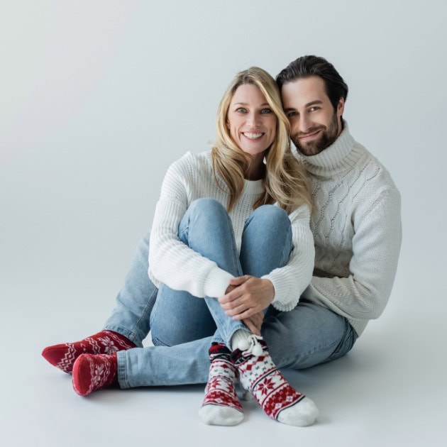 Cute couple wearing colorful, cozy socks for comfort and style. Perfect for home or casual wear.