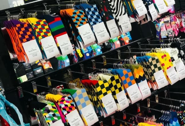 Brightly colored socks with geometric and playful patterns for all ages.