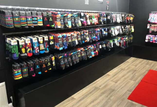 Brightly colored socks on store shelves for all ages.