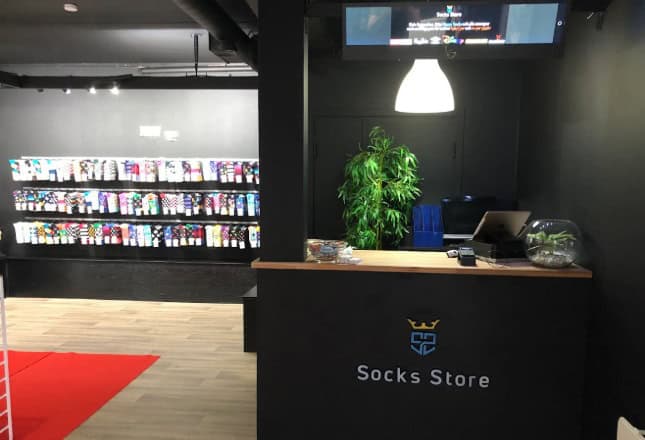 Socks Store reception area with display shelves of colorful socks.